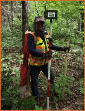 Surveyor with tools in the forest - Negaunee Ishpeming Iron Mountain Kingsford Norway Spread Eagle Auora